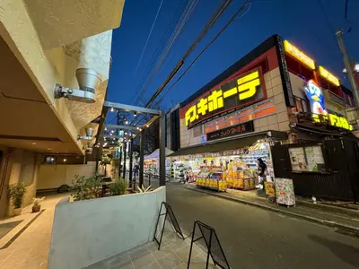 a store on the side of a city street at Hotel RIO\u65b0\u5bbf in Tokyo