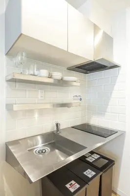 a kitchen with a stainless steel sink and cabinets at GrandTree Hotel - Specutaclor Skytree view! in Tokyo