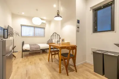 a kitchen and dining room with a table and a bed at GrandTree Hotel - Specutaclor Skytree view! in Tokyo