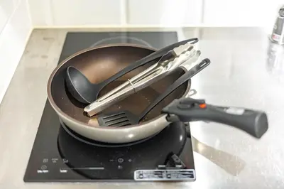 a pan with utensils on top of a stove at GrandTree Hotel - Specutaclor Skytree view! in Tokyo