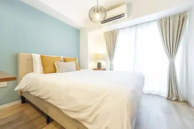 a bedroom with a large white bed and a window at GrandTree Hotel - Specutaclor Skytree view! in Tokyo