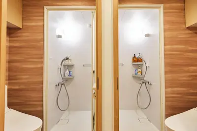 a bathroom with two shower stalls and a toilet at 新宿繁华市中心艺术公馆/交通便利/徒步三分钟伊势丹/商务出行便利/免费Wi-Fi in Tokyo