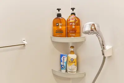 a bathroom with three bottles of soap and a shower at 新宿繁华市中心艺术公馆/交通便利/徒步三分钟伊势丹/商务出行便利/免费Wi-Fi in Tokyo