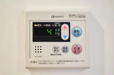 an electronic clock with buttons on a wall at 新宿繁华市中心艺术公馆/交通便利/徒步三分钟伊势丹/商务出行便利/免费Wi-Fi in Tokyo