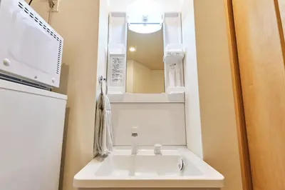 a bathroom with a sink and a mirror at 新宿繁华市中心艺术公馆/交通便利/徒步三分钟伊势丹/商务出行便利/免费Wi-Fi in Tokyo