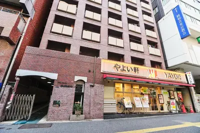 a brick building with a store on a city street at 新宿繁华市中心艺术公馆/交通便利/徒步三分钟伊势丹/商务出行便利/免费Wi-Fi in Tokyo