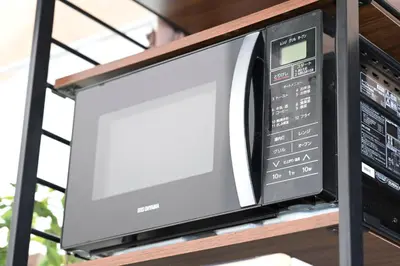 a microwave oven sitting on top of a shelf at AIC\u6c60\u888b502 in Tokyo