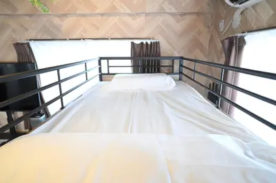 a large bed in a room with two windows at AIC\u6c60\u888b502 in Tokyo