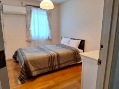 a bedroom with a bed and a window at Urban Residence Ikebukuro East in Tokyo