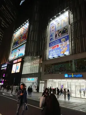 a group of people walking on a city street at night at Urban Residence Ikebukuro East in Tokyo