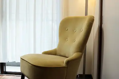 a yellow chair sitting in front of a window at EMA House 4P Free Wifi! in Tokyo