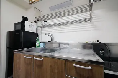 a kitchen with a sink and a black refrigerator at EMA House 4P Free Wifi! in Tokyo