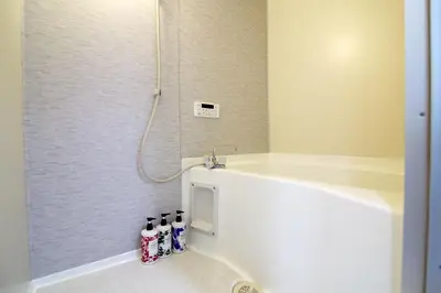 a bathroom with a shower with three soda bottles at EMA House 4P Free Wifi! in Tokyo