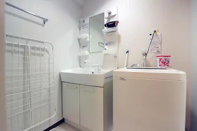 a white bathroom with a sink and a mirror at EMA House 4P Free Wifi! in Tokyo