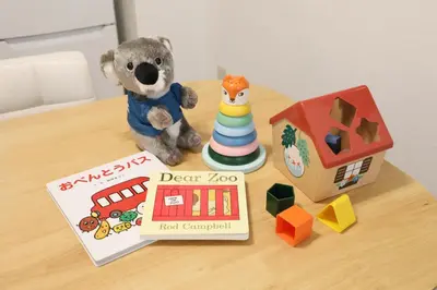 a stuffed teddy bear sitting on a table with a toy house at Vermidor Ebisu302 in Tokyo