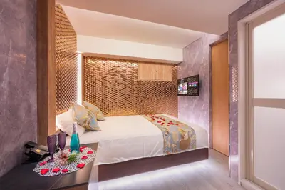 a bedroom with a bed and a table with flowers on it at Sakura Bella Ikebukuro in Tokyo