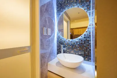 a bathroom with a sink and a mirror at Sakura Bella Ikebukuro in Tokyo