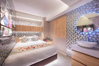 a bedroom with a large bed and a sink at Sakura Bella Ikebukuro in Tokyo