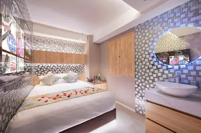 a bedroom with a bed and a sink and a bathroom at Sakura Bella Ikebukuro in Tokyo