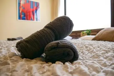 a sock on top of a bed at KODAKA Hotel TOKYO in Tokyo