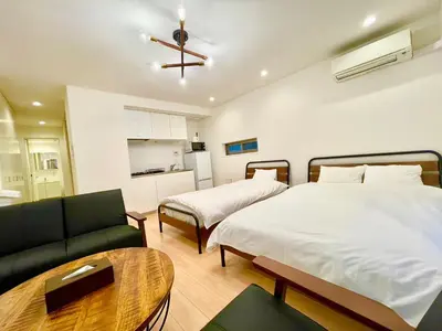 a hotel room with two beds and a couch at SALON\u6e0b\u8c374B in Tokyo