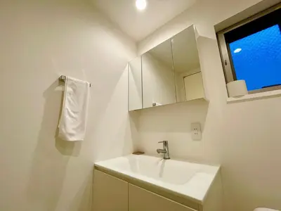 a white bathroom with a sink and a mirror at SALON\u6e0b\u8c374B in Tokyo