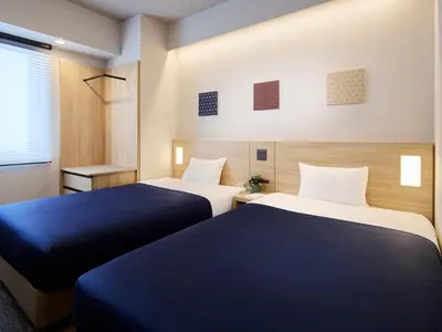 two beds in a room with blue and white at Minn Ueno Shin-Okachimachi in Tokyo