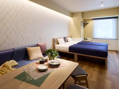 a room with a bed and a table and a couch at Minn Ueno Shin-Okachimachi in Tokyo