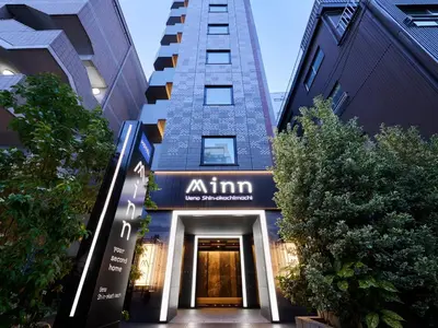a building with a sign that reads am inn at Minn Ueno Shin-Okachimachi in Tokyo