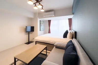 a living room with a bed and a couch at Sky Kinshicho in Tokyo