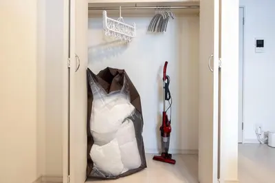 a room with a closet with a bag of clothes at Sky Kinshicho in Tokyo