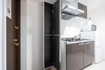 a small kitchen with a sink and a stove at Sky Kinshicho in Tokyo