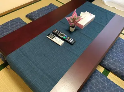 a table with two remote controls and a plant on it at \u30e1\u30be\u30f3\u516b\u5343\u4ee3102 in Tokyo