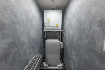 a small bathroom with a toilet in a wall at Inn The Omotesando in Tokyo