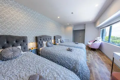 a bedroom with two beds and a window at Inn The Omotesando in Tokyo