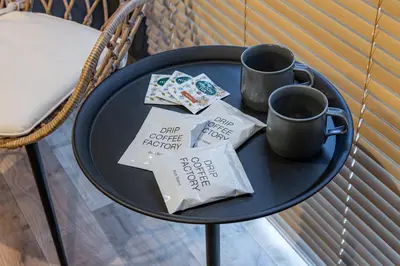 a blue table with two cups and some receipts on it at Inn The Omotesando in Tokyo