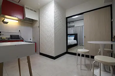a kitchen and living room with a table and chairs at Shinjuku! Hayashi House 3P Free Wi-fi! in Tokyo