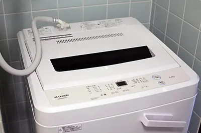a washer and dryer in a utility room at Shinjuku! Hayashi House 3P Free Wi-fi! in Tokyo
