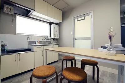 a kitchen with a table and two stools in it at Shinjuku! Hayashi House 3P Free Wi-fi! in Tokyo