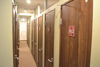 a row of wooden lockers in a hallway at 1 Night 1980 Hostel Tokyo Asakusa Simple Stay in Tokyo