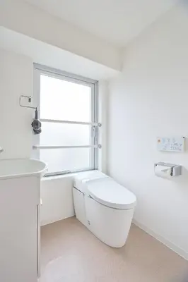 a white bathroom with a toilet and a window at Regnocomfort Asakusa 3 - Vacation STAY 57925v in Tokyo