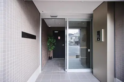 an entrance to a building with a door and a plant at Regnocomfort Asakusa 3 - Vacation STAY 57925v in Tokyo