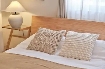 a bedroom with a bed with two pillows and a lamp at Regnocomfort Asakusa 3 - Vacation STAY 61882v in Tokyo