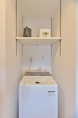 a washer and dryer in a kitchen with a shelf at Regnocomfort Asakusa 3 - Vacation STAY 61882v in Tokyo
