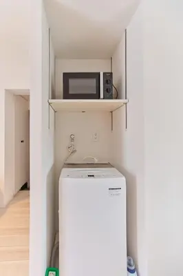 a small kitchen with a refrigerator and a microwave at Regnocomfort Asakusa 3 - Vacation STAY 61883v in Tokyo
