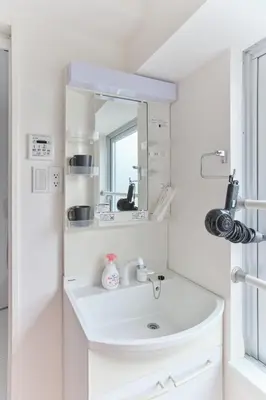 a white bathroom with a sink and a mirror at Regnocomfort Asakusa 3 - Vacation STAY 61883v in Tokyo