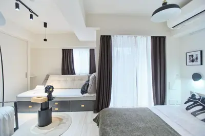 a bedroom with two beds and a window at Regnocomfort Asakusa 3 - Vacation STAY 57915v in Tokyo