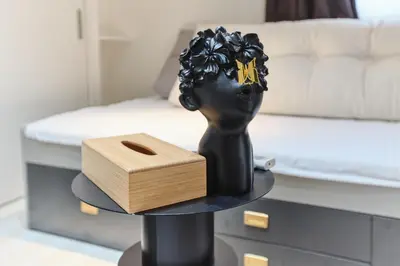 a black statue and a wooden box on a table at Regnocomfort Asakusa 3 - Vacation STAY 57915v in Tokyo