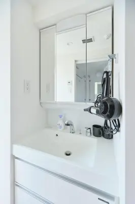 a white bathroom with a sink and a mirror at Regnocomfort Asakusa 3 - Vacation STAY 57915v in Tokyo
