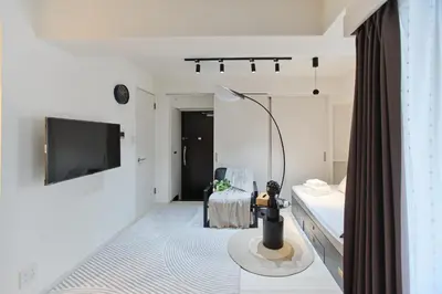 a white room with a bed and a lamp at Regnocomfort Asakusa 3 - Vacation STAY 57915v in Tokyo